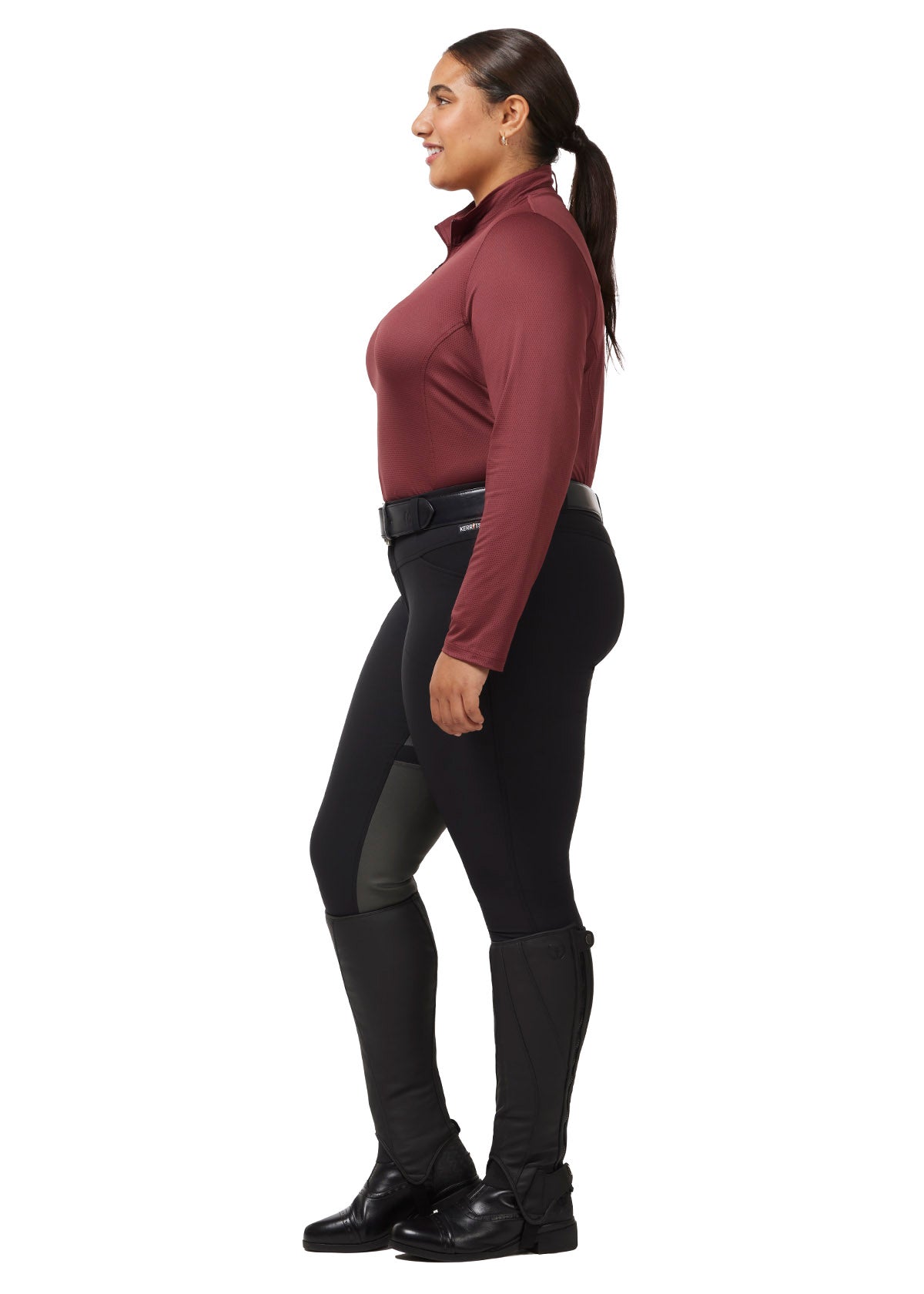 Side profile of a model wearing the Kerrits Ice Fil® Lite Long Sleeve Riding Shirt, showcasing the ergonomic seams and long sleeves.