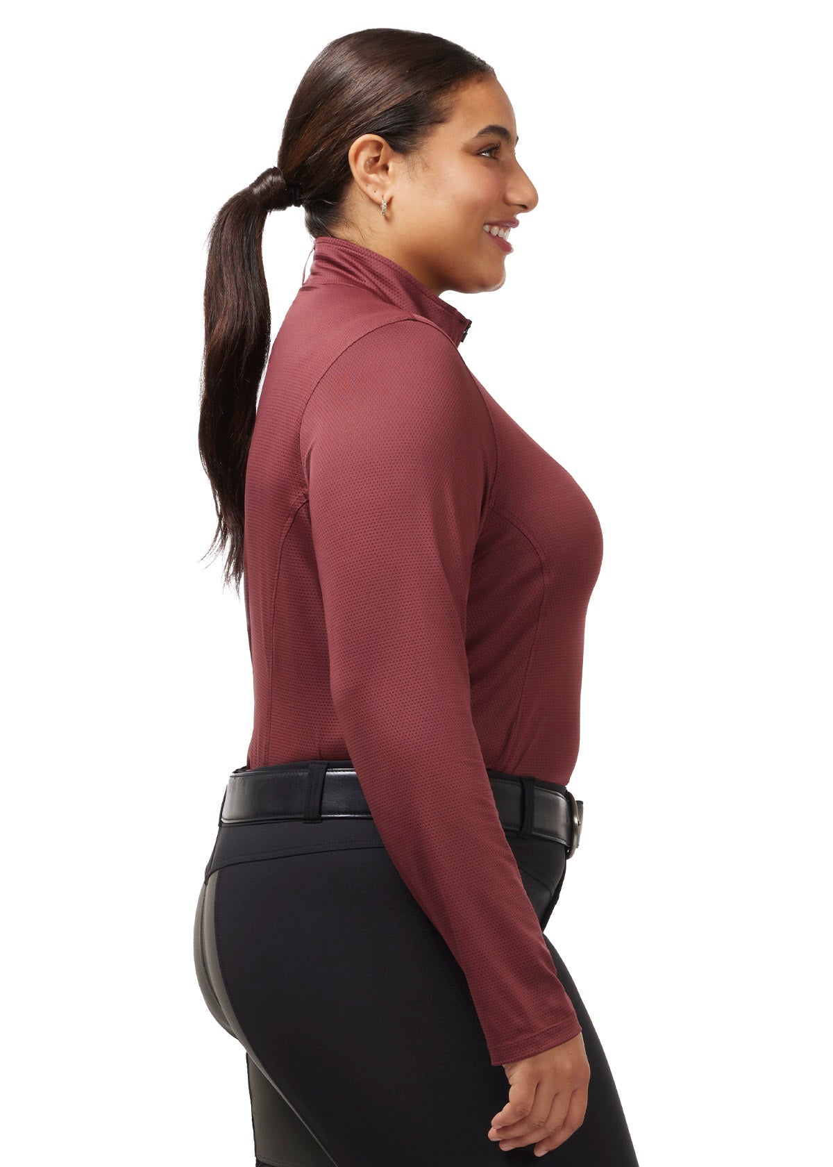 ide profile of a model wearing the Kerrits Ice Fil® Lite Long Sleeve Riding Shirt in Burgundy, showcasing the ergonomic seams and long sleeves.