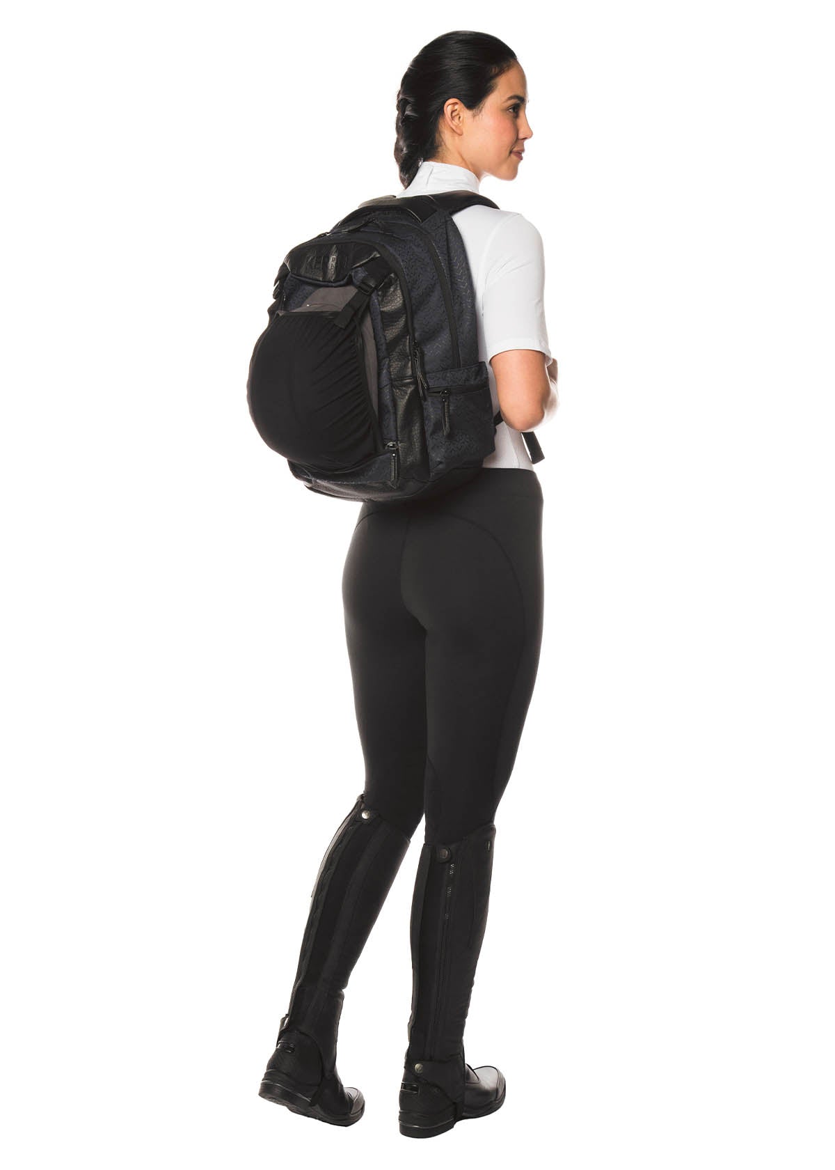 Model wearing the Kerrits EQ Backpack in black, demonstrating the compact yet spacious design for equestrian activities.