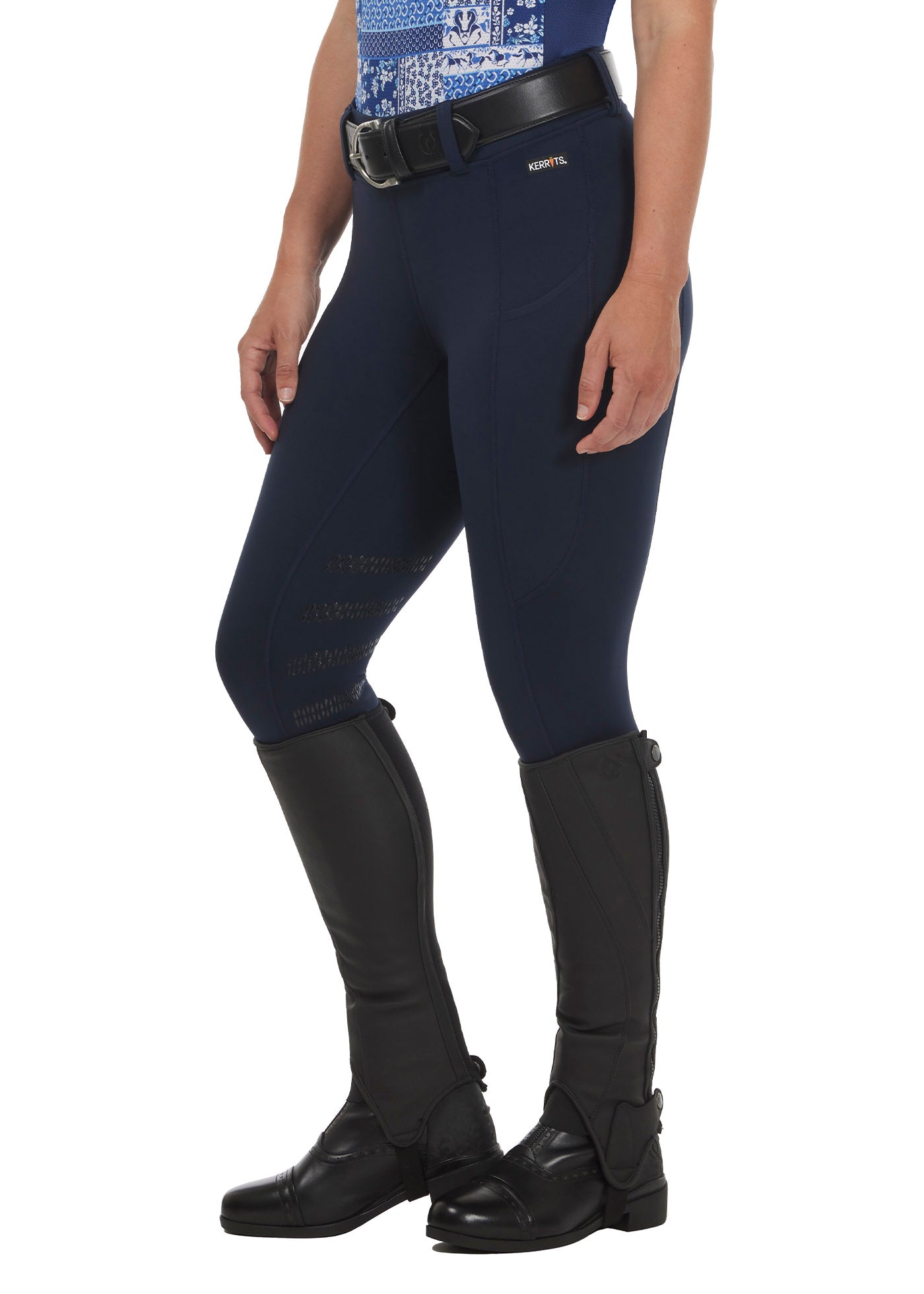 Model wearing the Flex Lite Knee Patch Riding Tight in Galaxy Blue, highlighting the athletic fit and flexible movement for equestrian performance.