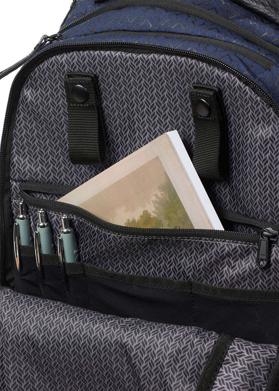 Detailed view of the Kerrits EQ Backpack fabric in Navy, highlighting roomy interior, large zip pocket and pen holders."