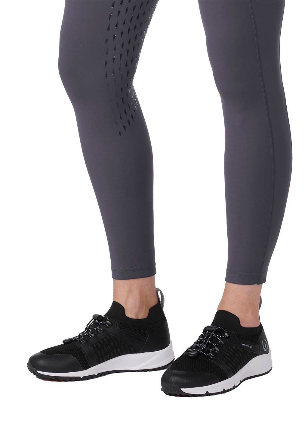 Close-up view of the full-leg Kerrit Sticks™ silicone grip from inner thigh to calf.