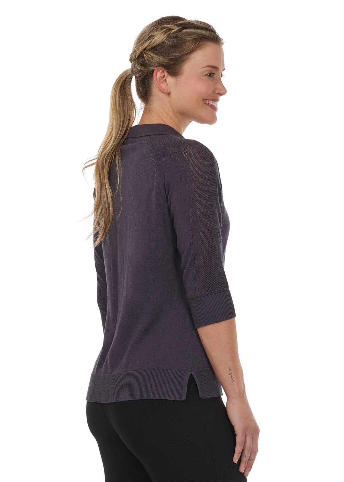 Left side view of the Bit of Breeze Sweater Knit Polo in Abyss, showcasing the subtle equestrian-inspired pointelle design on the shoulder and sleeve.