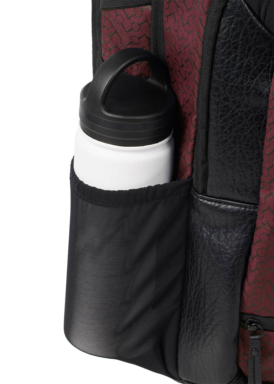 Close-up of the Kerrits EQ Backpack, showing the side mesh bottle compartment to make sure you stay hydrated.
