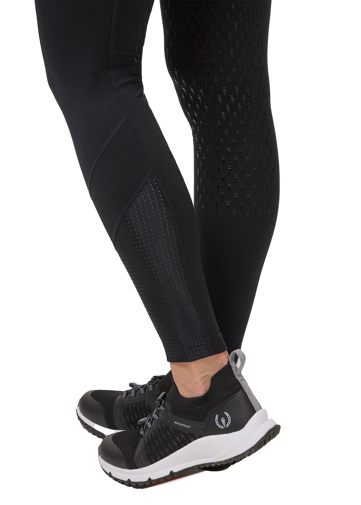 Close-up of the Free Style Knee Patch Pocket Tight on a model in Black Solid, focusing on the knee patch and mesh panel details.