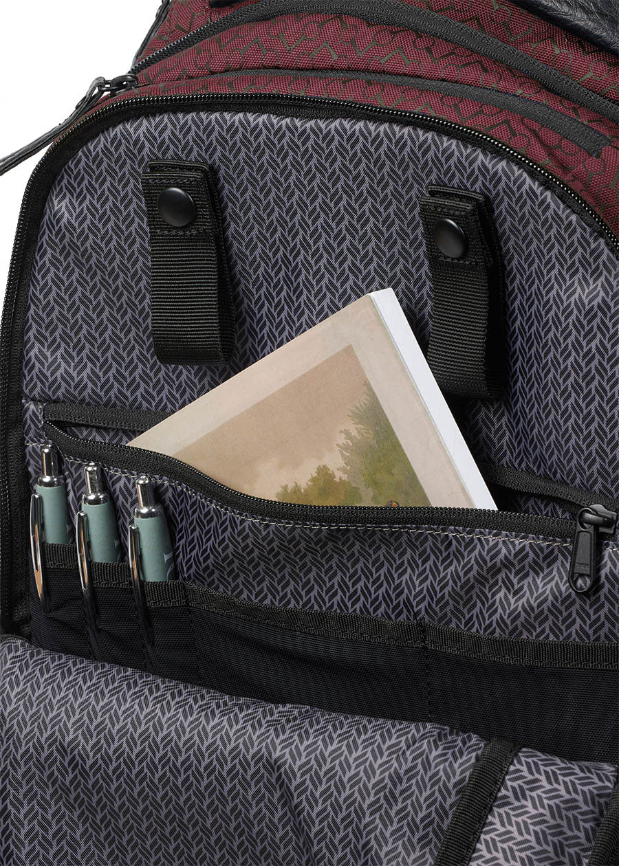 Detailed view of the Kerrits EQ Backpack fabric in Burgundy, highlighting roomy interior, large zip pocket and pen holders."