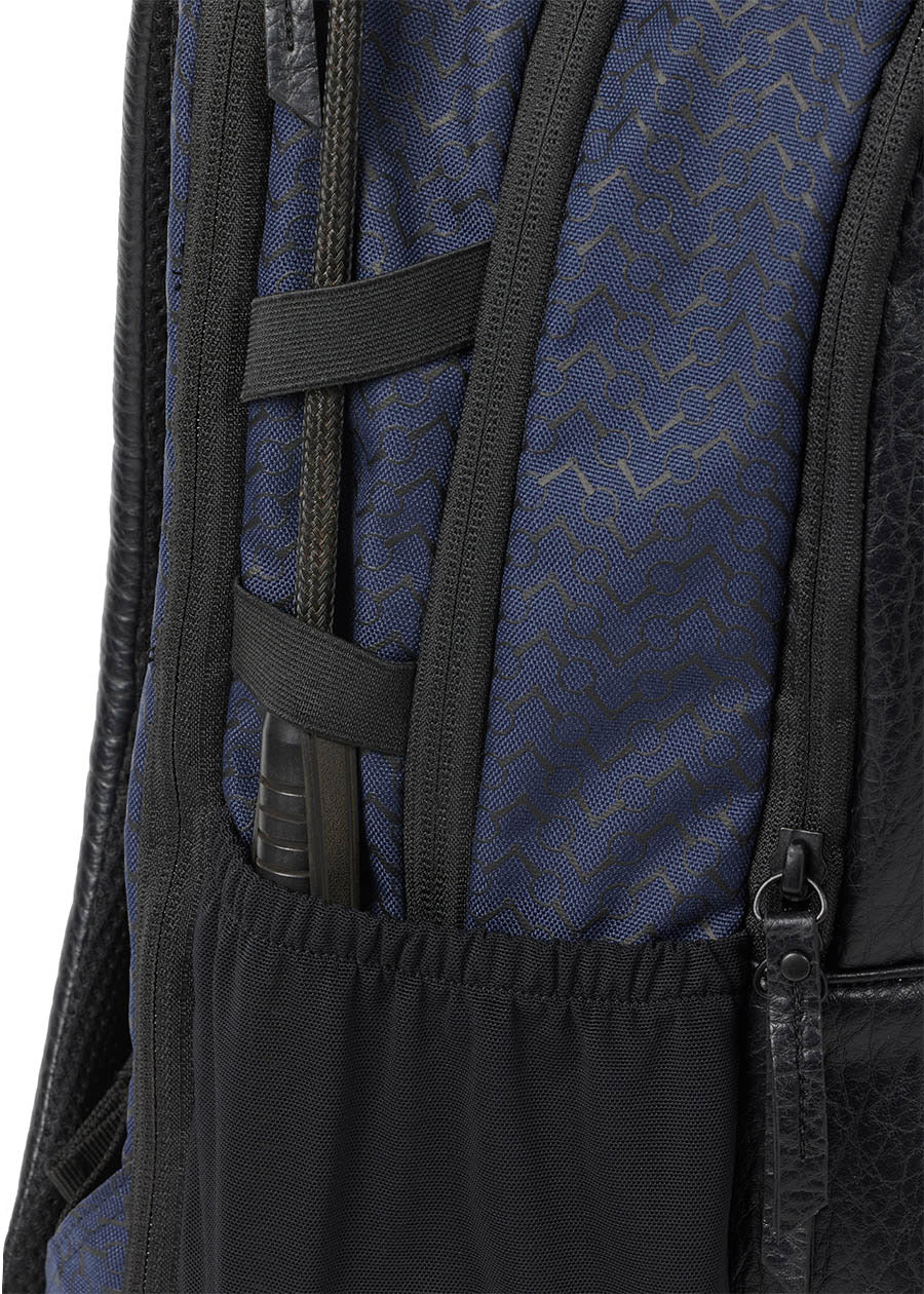 Detailed view of the side of Kerrits EQ Backpack in Navy, highlighting the riding crop holder.