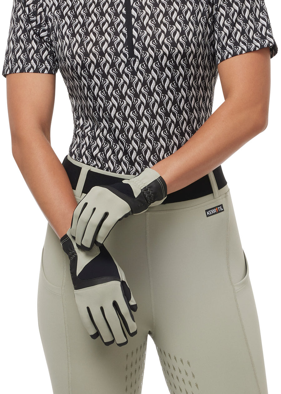 Model wearing the Coolcore® Riding Gloves in Sand, showing the snug fit and flexible design perfect for riding in hot weather.
