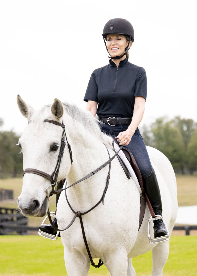 Individual wearing the Kerrits Ice Fil® Lite Short Sleeve Riding Shirt during a training session, showcasing its moisture-wicking properties.
