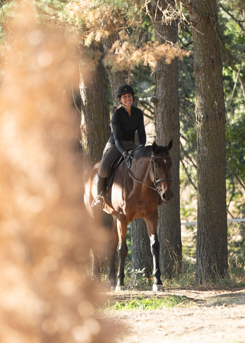 Rider wearing the Kerrits Ice Fil® Lite Long Sleeve Riding Shirt during an outdoor ride, highlighting the shirt's UPF 30+ sun protection.