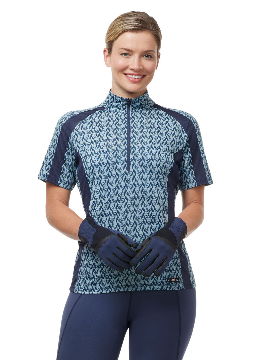 Model wearing the Coolcore® Riding Gloves in Nightsky, showing them as a matching part of a full blue riding outfit.