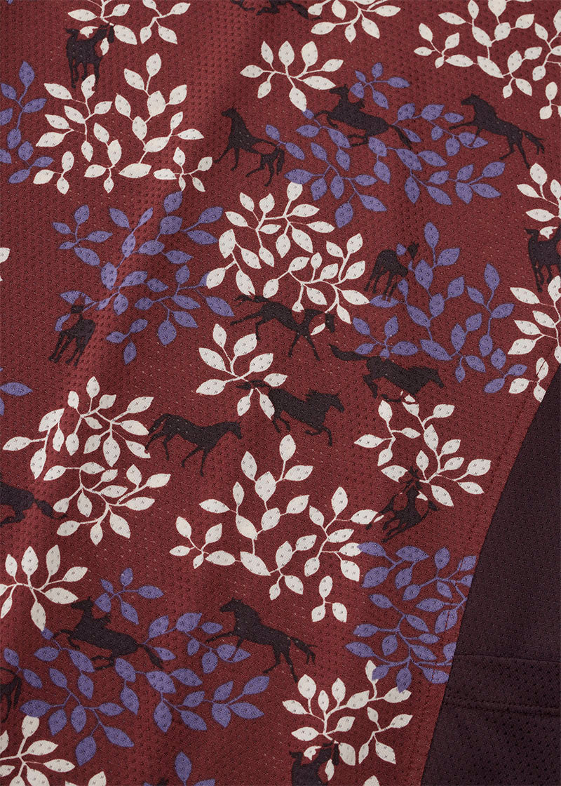 Close-up of the Ice Fil® Lite fabric on the Breeze Short Sleeve Shirt in Amberspice Branching Out print, showing the equestrian details in the print.
