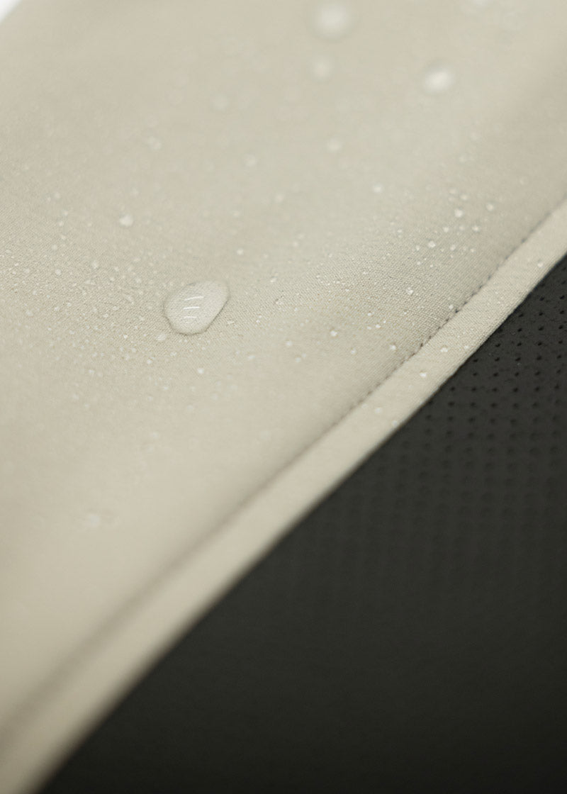 Close-up of the Dynamic Extreme fabric with water droplets, showcasing the water-resistant properties of this fabric.