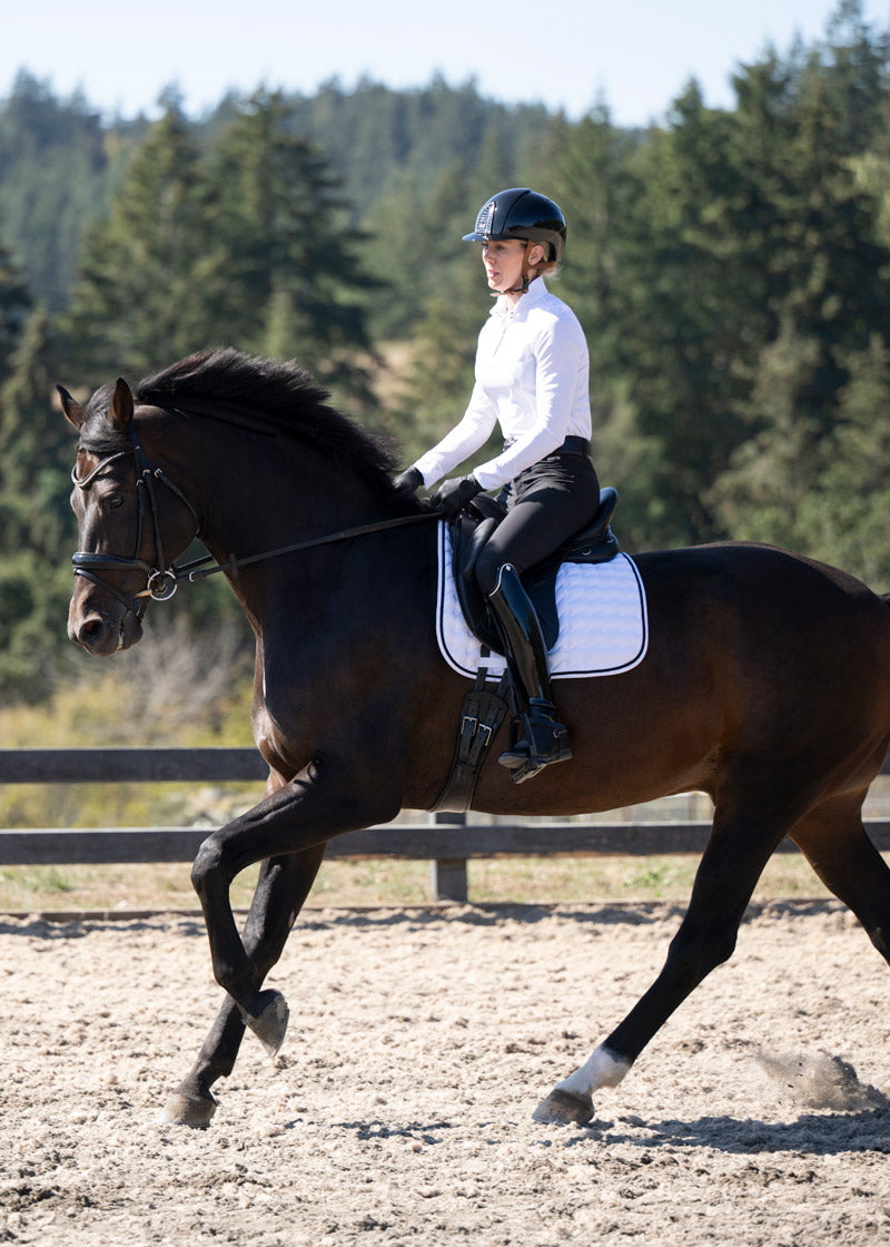 Rider in the Crossover II® Knee Patch Riding Breech in black, paired with a white show shirt for a perfect schooling outfit.