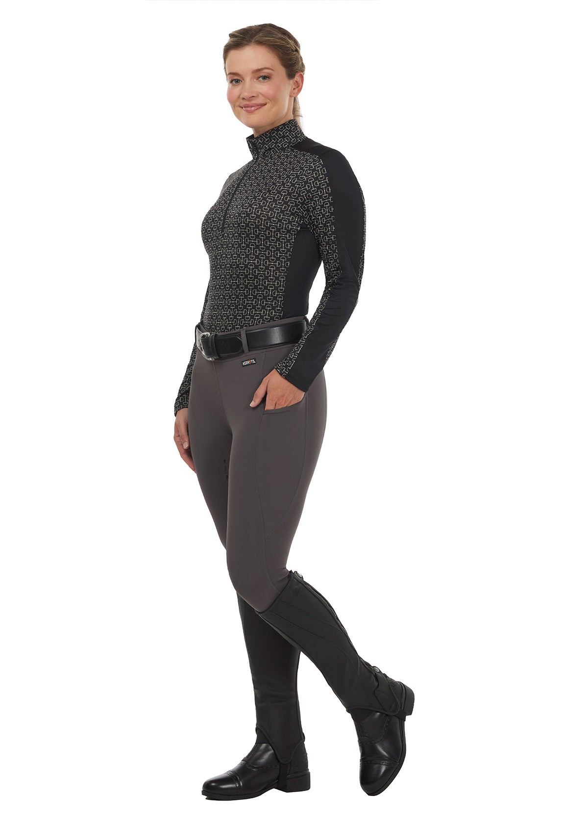Model wearing the Coolcore Full Leg Tech Tight in Castiron, paired with a long sleeve riding top for a sophisticated equestrian look.