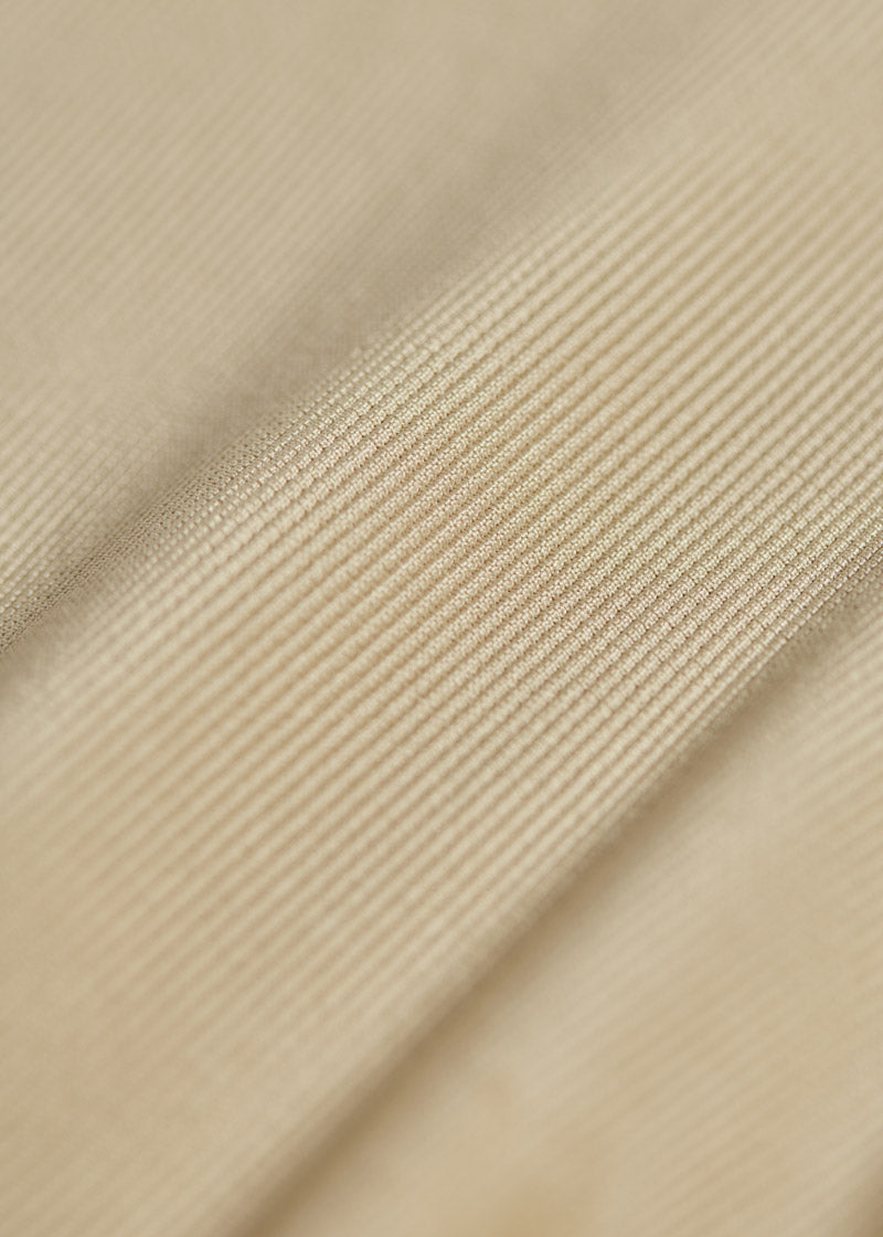 Detailed shot of the ribbed Microcord™ fabric, highlighting its four-way stretch and compression qualities that offer muscle support and shape retention