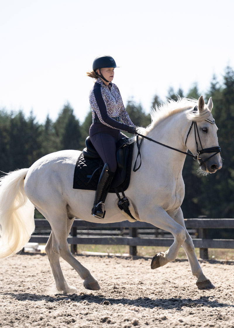 Equestrian wearing the Kerrits K-Flex™ Full Seat Breech during an outdoor ride, highlighting the breech's performance and comfort in the saddle.