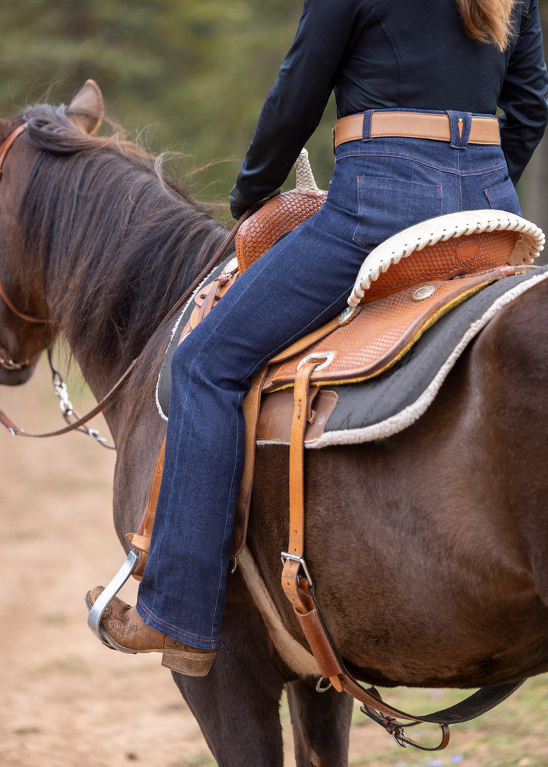 Equestrian wearing the riding pants while mounted, demonstrating the in-saddle performance and comfort
