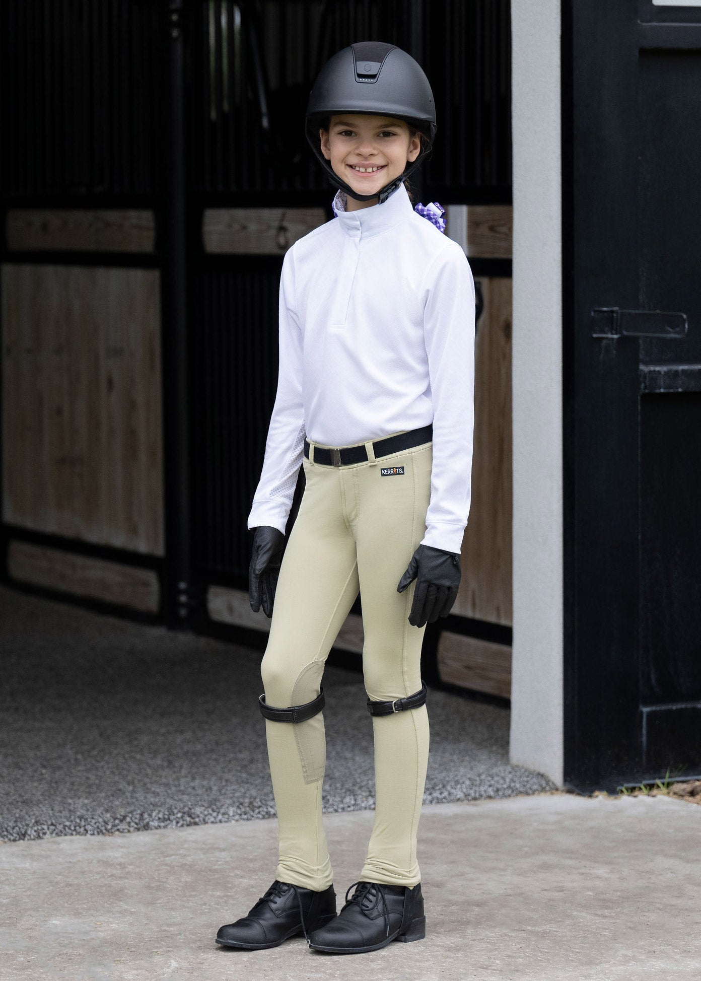 Rider standing dressed in the Encore Long Sleeve Show Shirt, highlighting the professional and stylish appearance suitable for competitions
