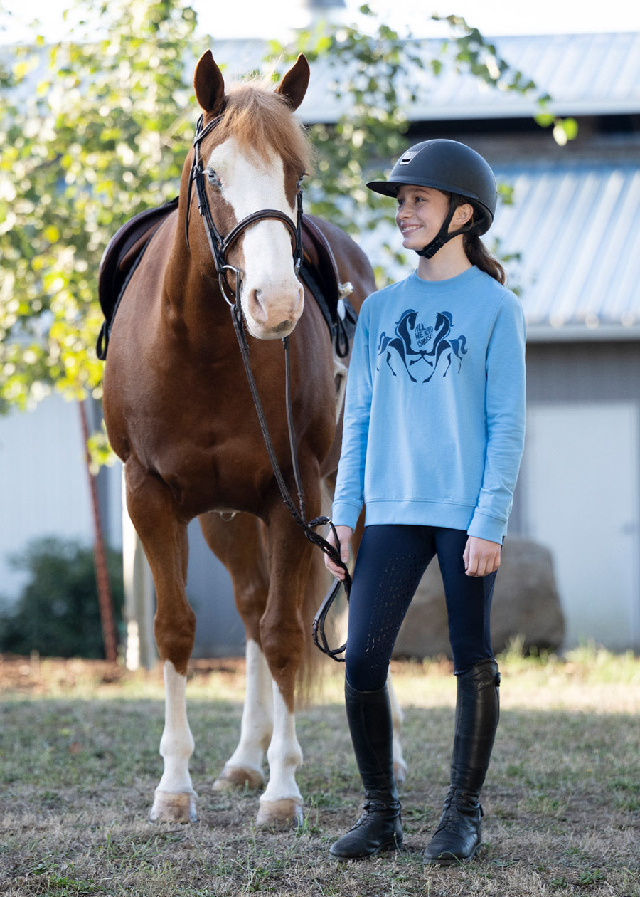 Rider posing with a horse, wearing the sweatshirt, capturing the spirit of youthful equestrian enthusiasm