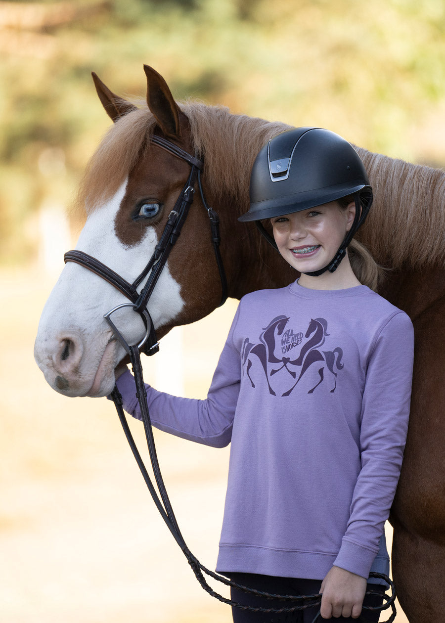 Rider posing with a horse, wearing the sweatshirt, capturing the spirit of youthful equestrian enthusiasm