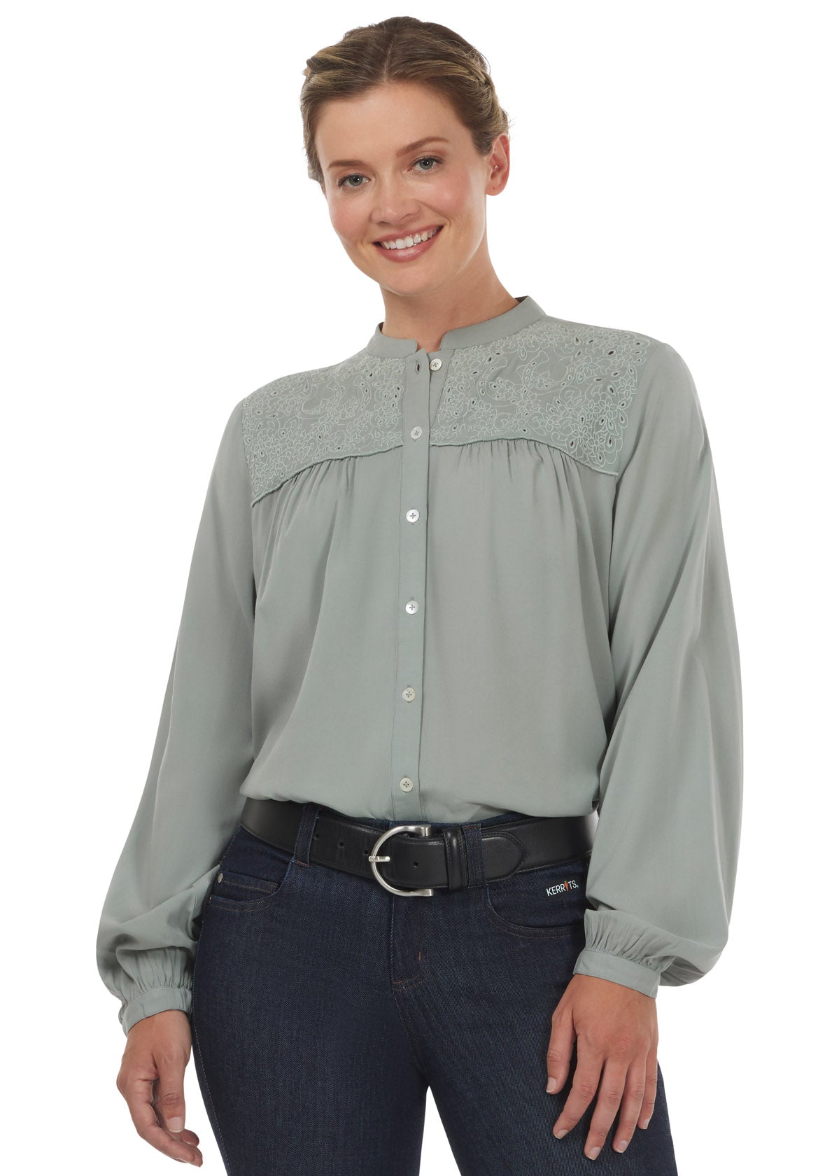 Front view of the Kerrits Hollyhocks & Horseshoes Blouse in Celadon, highlighting the floral horseshoe cutout embroidery on the front yoke.