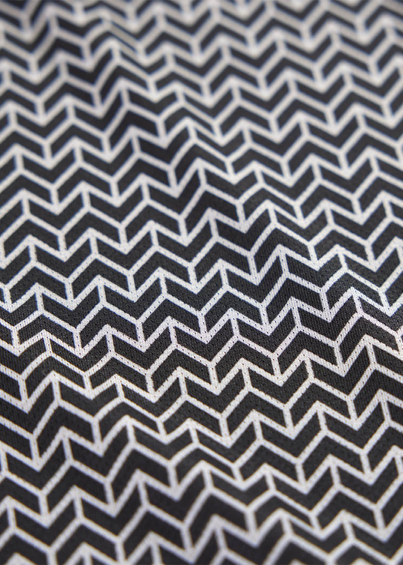 Detailed shot of the Coolcore® fabric, illustrating its lightweight, moisture-wicking properties that help manage and distribute body heat