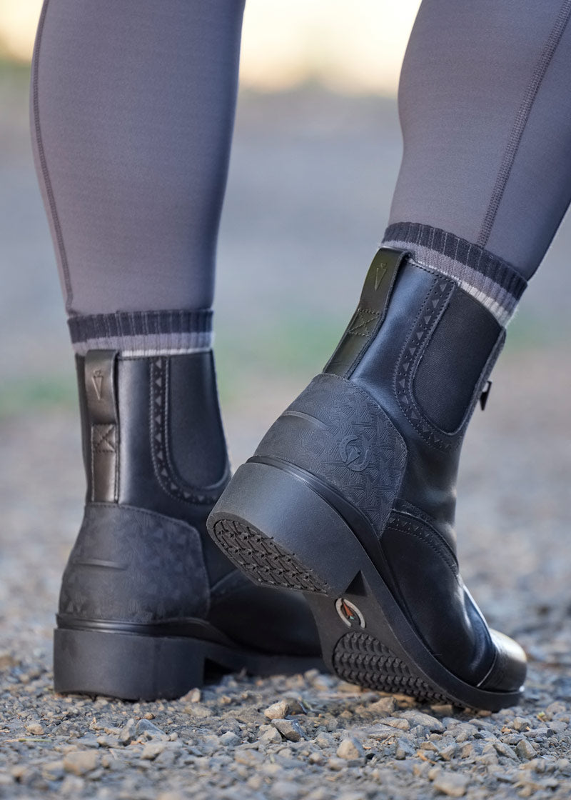Back view of Kerrits Essence Waterproof Paddock Boot displaying the leather pull-tab and SpurSync™ molded heel designed for secure spur positioning.