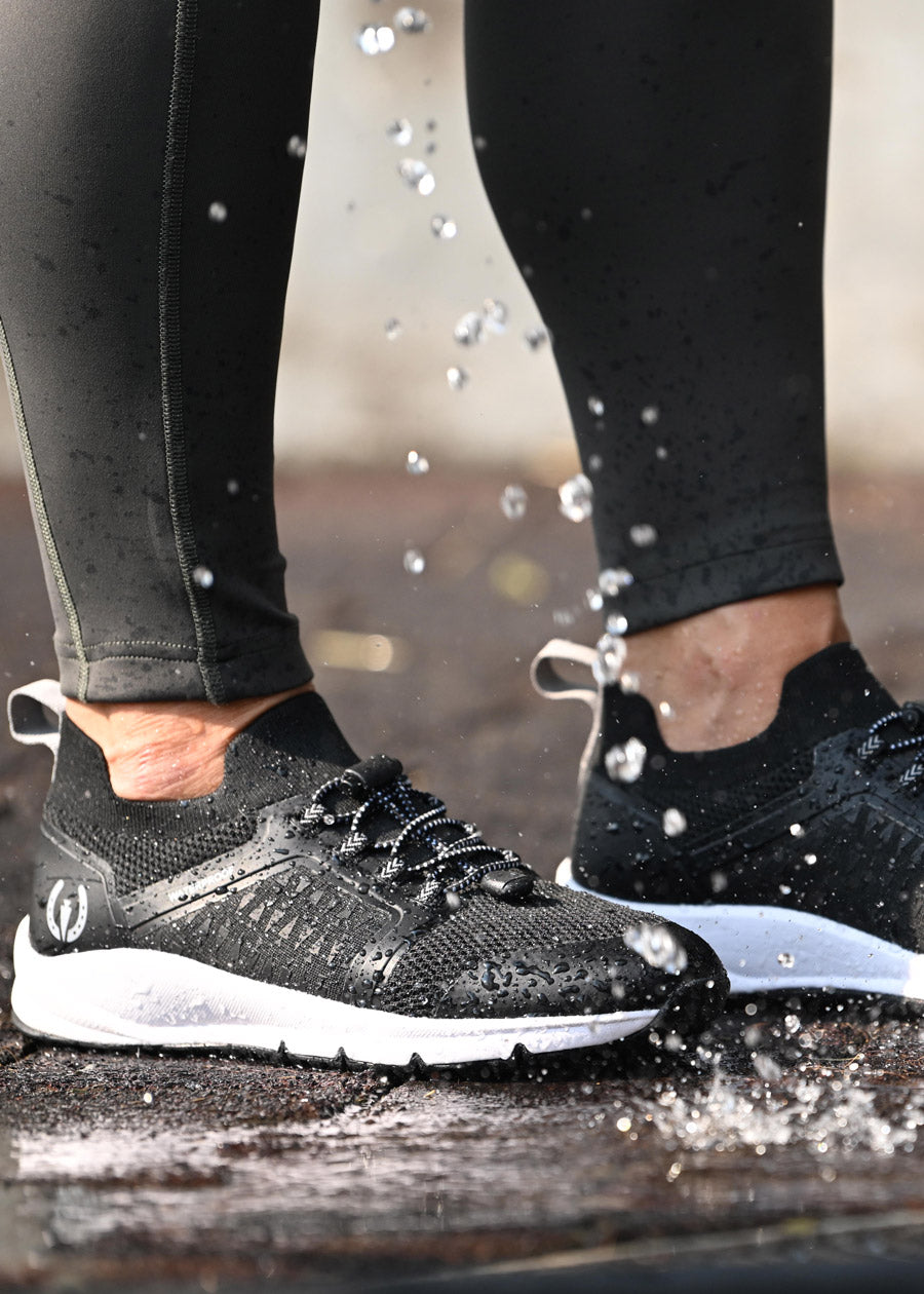 Close-up of the Groundwork Waterproof Sneakers being hosed off, showcasing the easy-to-clean, water-resistant material.
