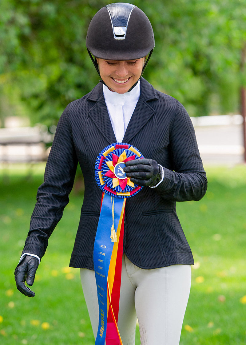 Equestrian wearing the Encore Short Sleeve Show Shirt during a competition, demonstrating its breathable comfort and elegant design.