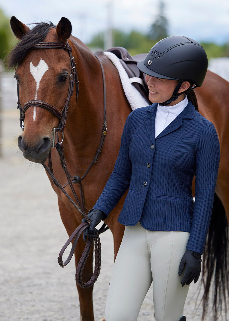 Young rider wearing the Encore Long Sleeve Show Shirt demonstrating the shirt's professional appearance and comfortable fit under a show coat