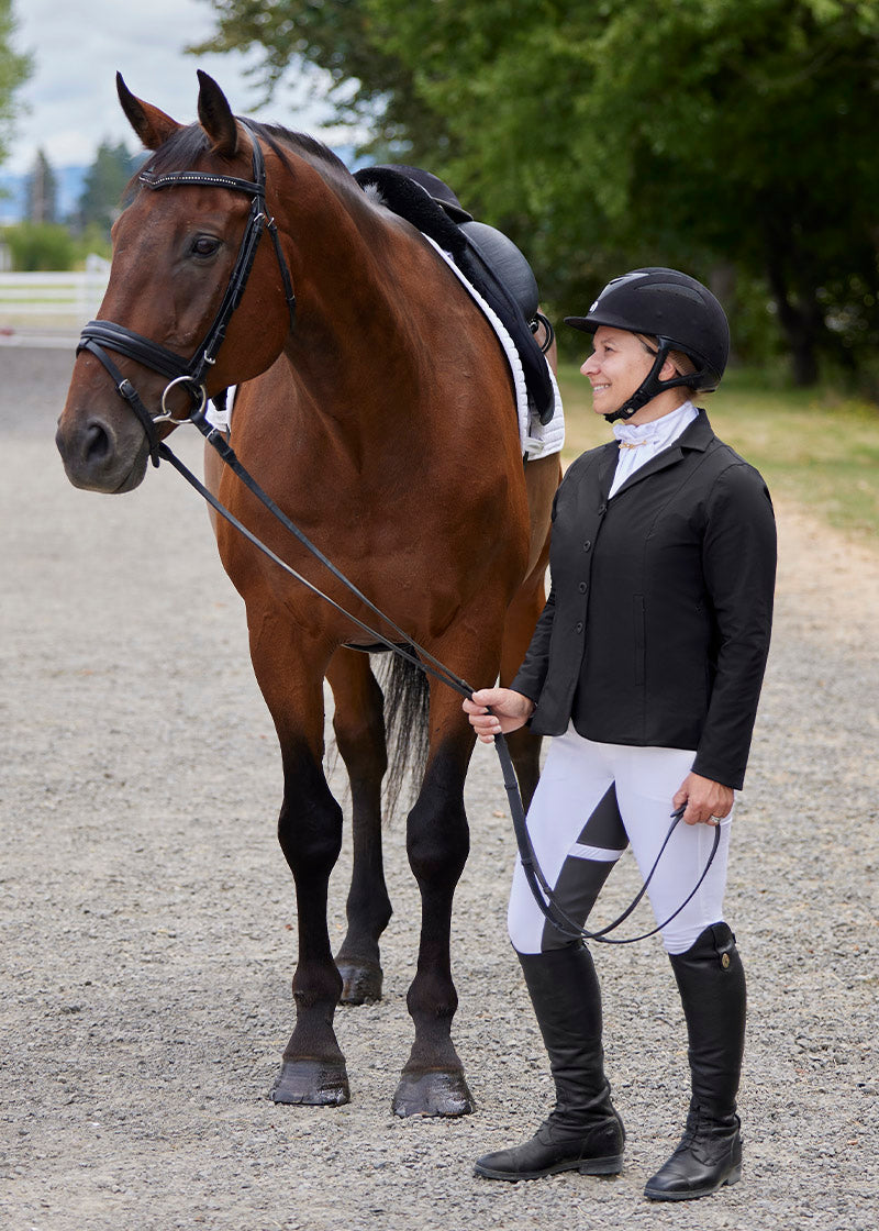 Rider pairing the breeches with a coordinating top and boots, showcasing a complete equestrian outfit