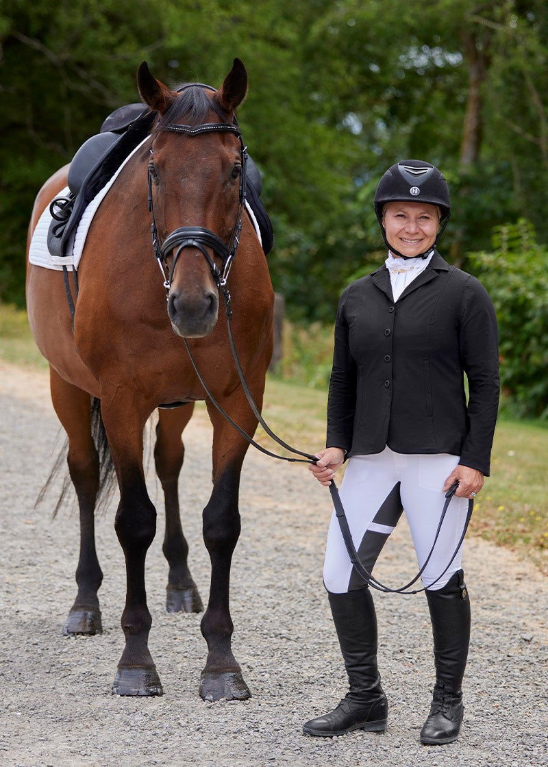 Person wearing the coat outdoors, highlighting its classic equestrian style