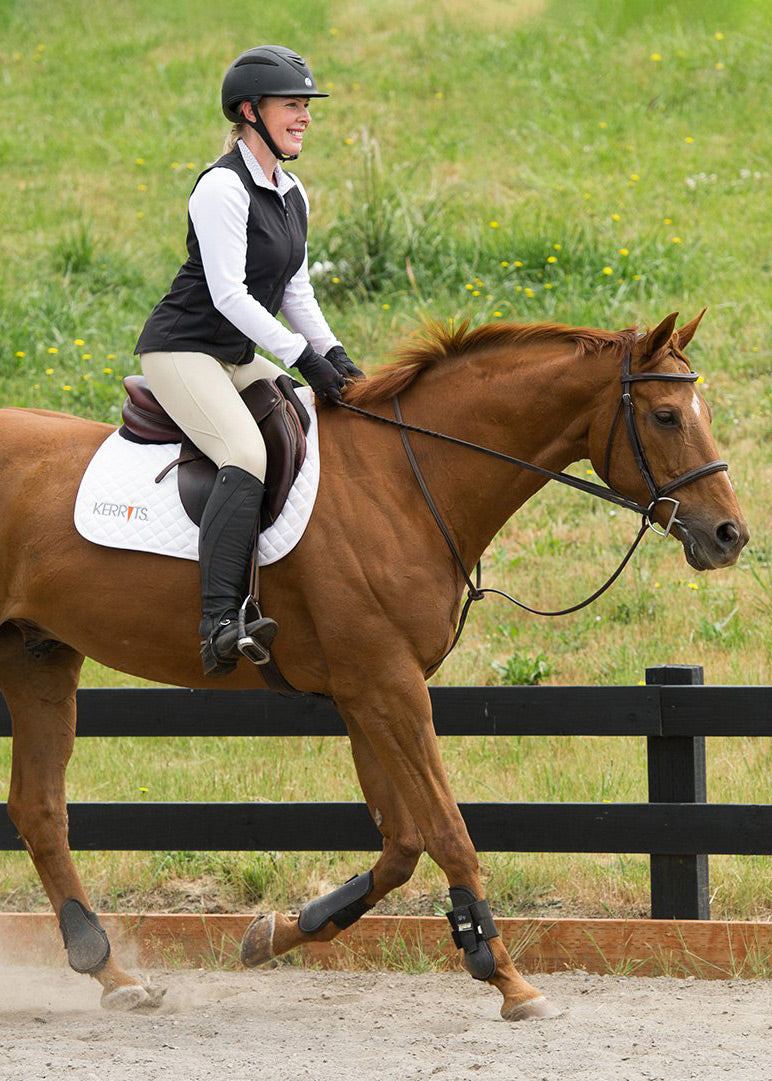 Horse wearing the Kerrits Saddle Pad during a ride, demonstrating its fit and functionality