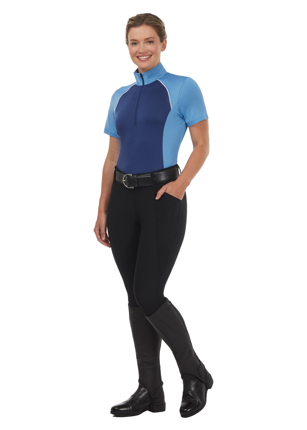 Model wearing the Charisma Coolcore Short Sleeve Riding Shirt in Lapis, styled with black breeches for a functional summer riding outfit.