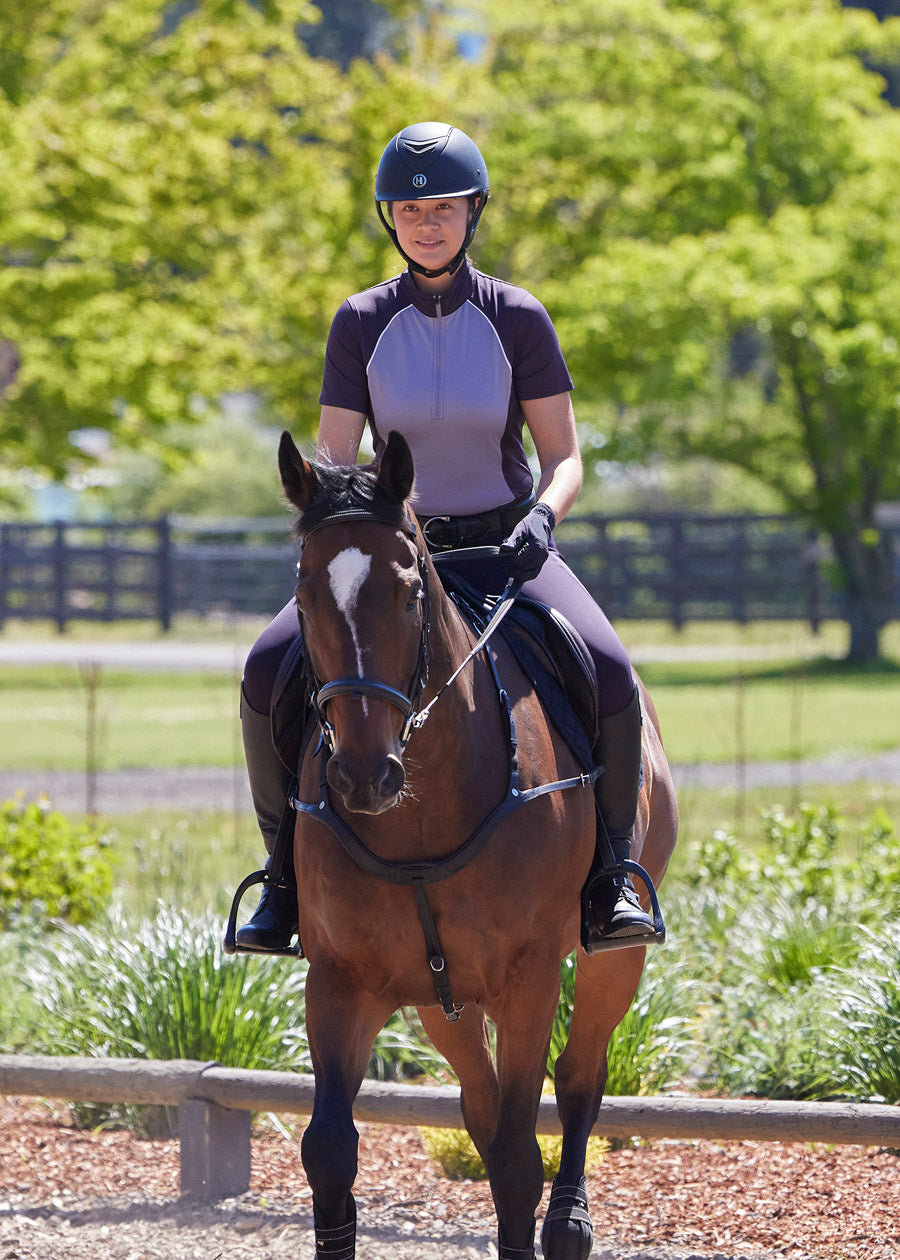 Rider cantering in the Charisma Coolcore Short Sleeve Riding Shirt in Silverberry, enjoying its cooling and moisture-wicking properties.
