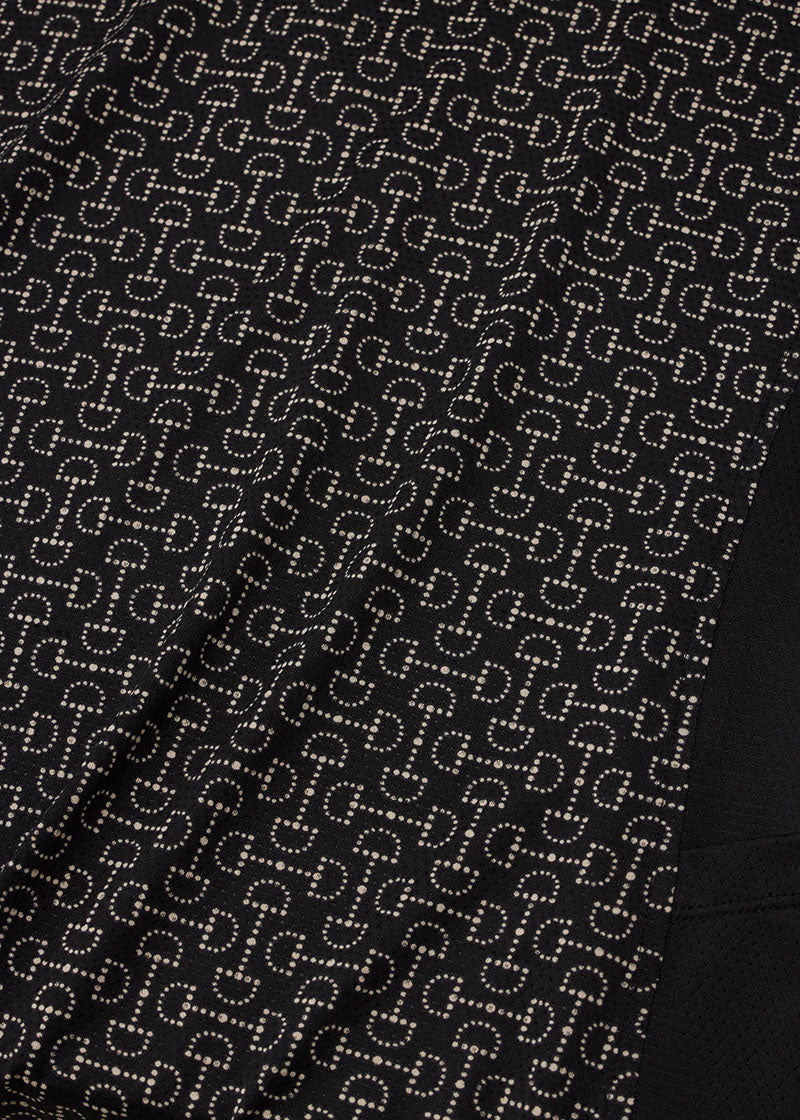 Close-up of the Ice Fil® Lite fabric on the Breeze Short Sleeve Shirt in Black Connect The Bits print, showing the equestrian details in the print.