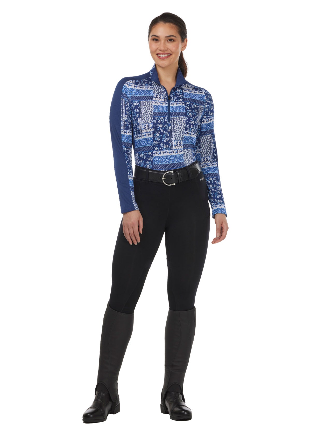 Model wearing the Breeze Ice Fil® Long Sleeve Riding Shirt in Lapis Patchwork, paired with breeches for a stylish summer equestrian outfit.