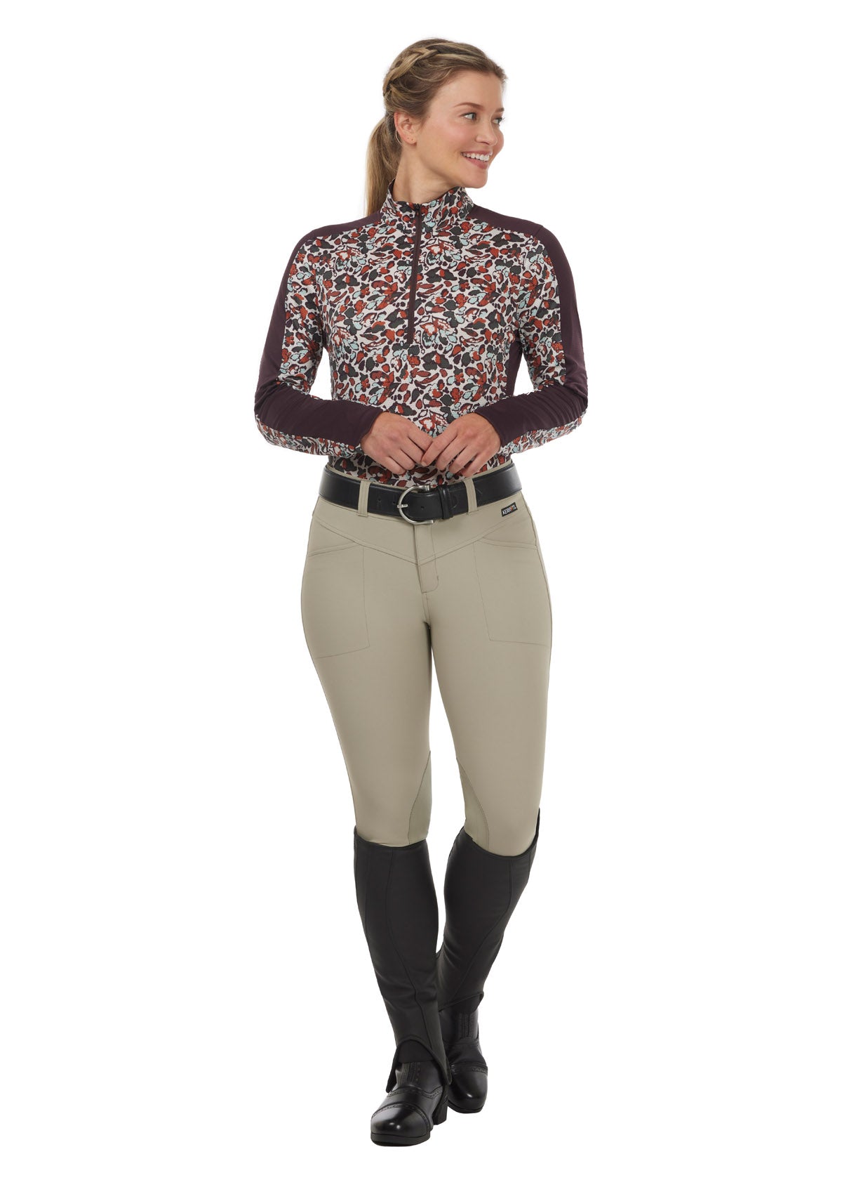 Model wearing the Breeze Ice Fil® Long Sleeve Riding Shirt in Terracotta Springtime, paired with tan breeches for a stylish summer equestrian outfit.