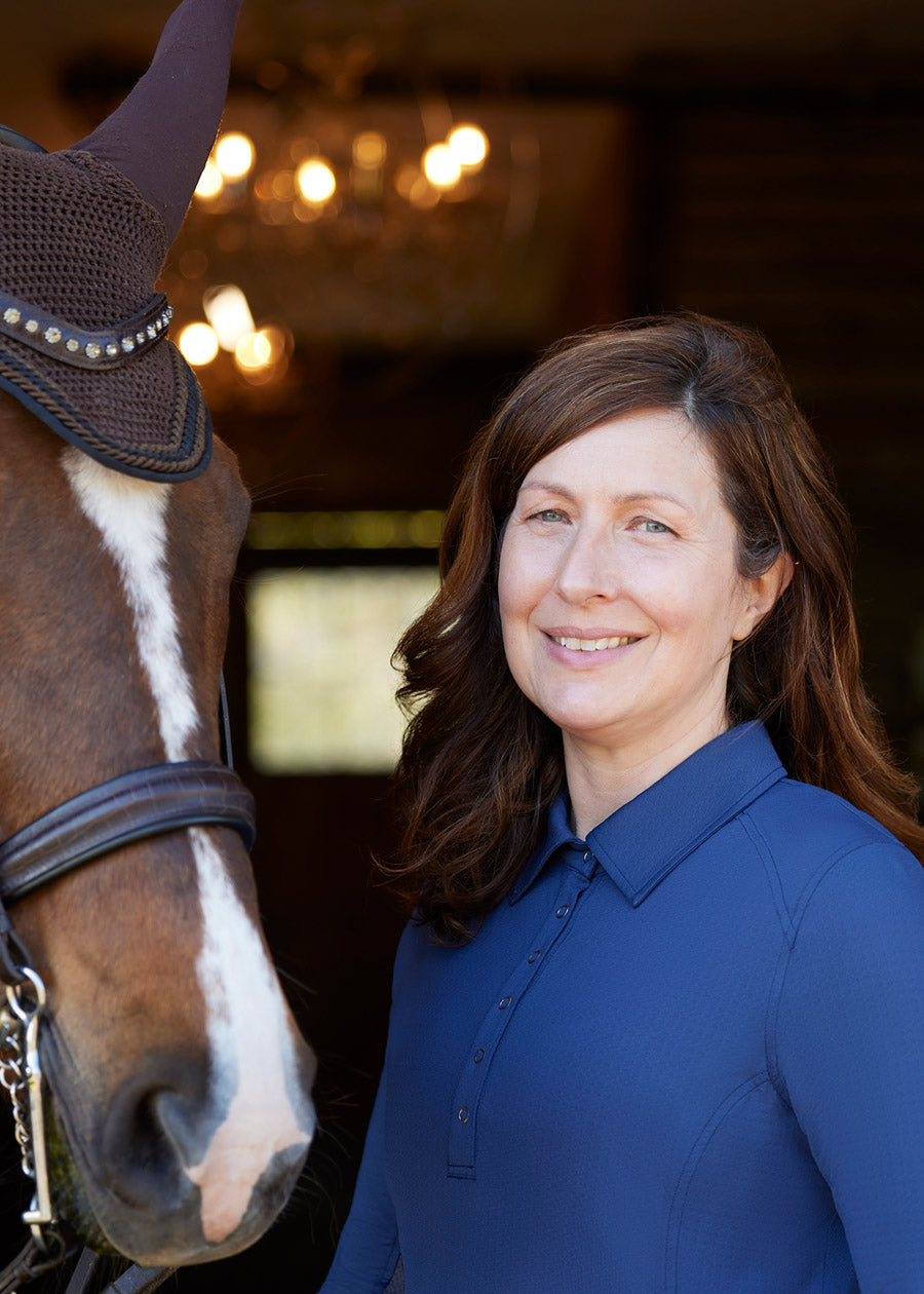 Close-up of the Kerrits In a Snap Long Sleeve Equestrian Clinic Shirt on a model, focusing on the shirt collar, snap placket, and fabric texture.