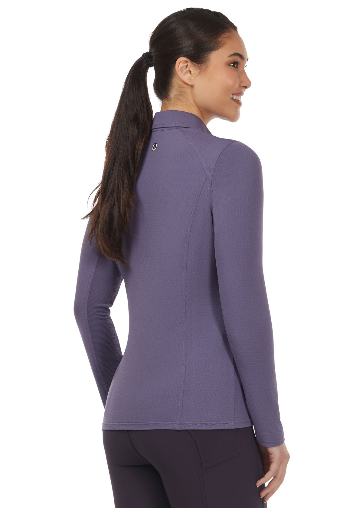 Back view of the Kerrits In a Snap Long Sleeve Equestrian Clinic Shirt in Wild Orchid, showcasing the hip-length design with an equestrian-shaped hem.