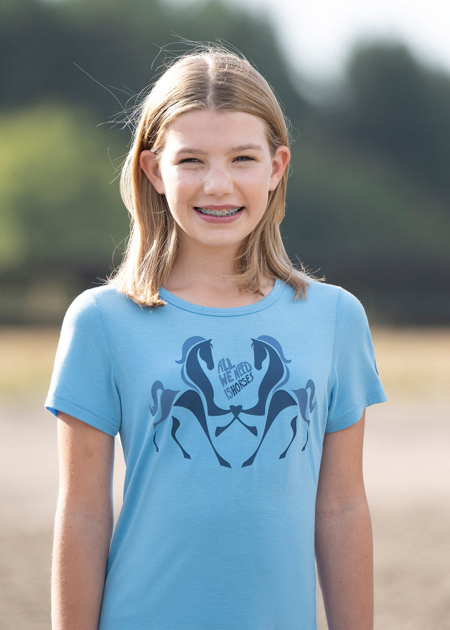Close-up of the rider's upper body, highlighting the graphic design and the tee's fit during riding activities