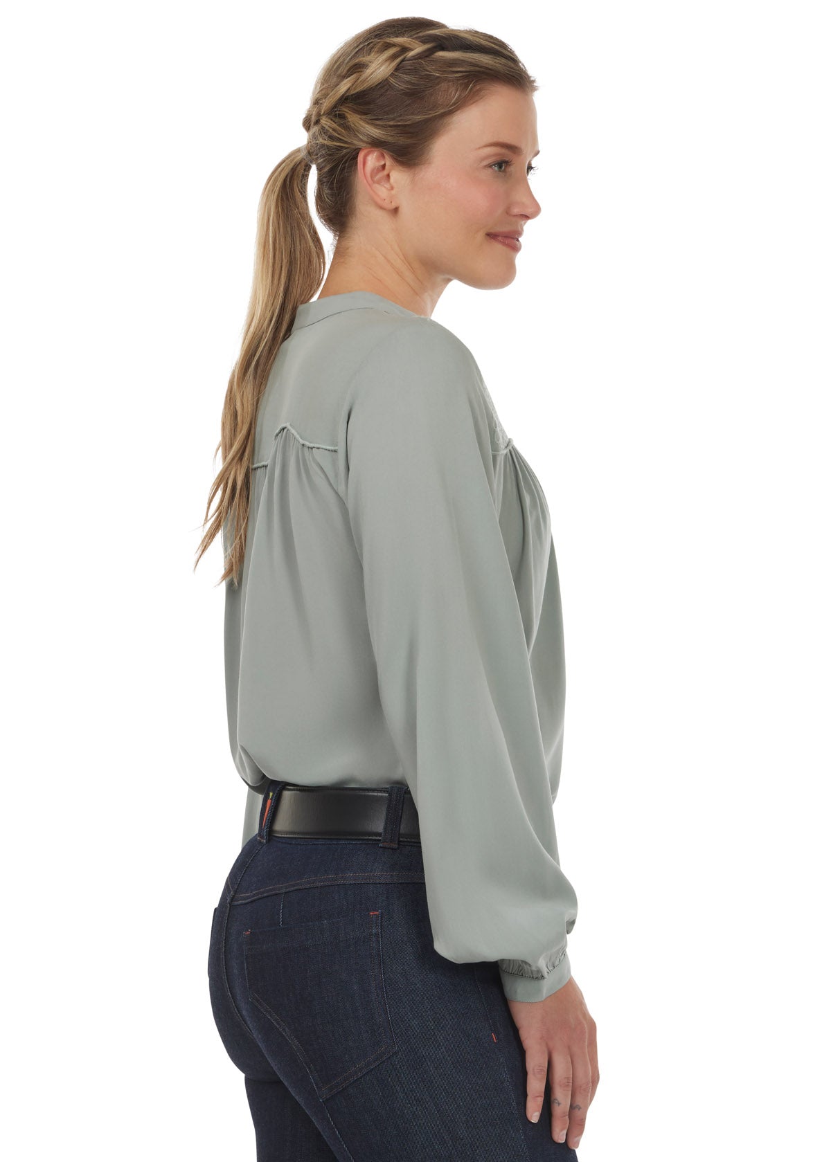 Side view of the Kerrits Hollyhocks & Horseshoes Blouse in Celadon, displaying the flowy design and long sleeves.
