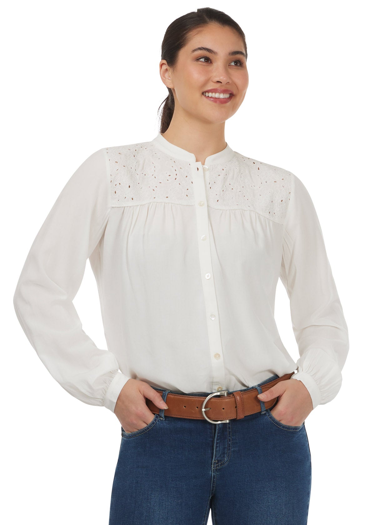Model wearing the Kerrits Hollyhocks & Horseshoes Blouse in Soft White, highlighting the floral horseshoe embroidery and flowy design.