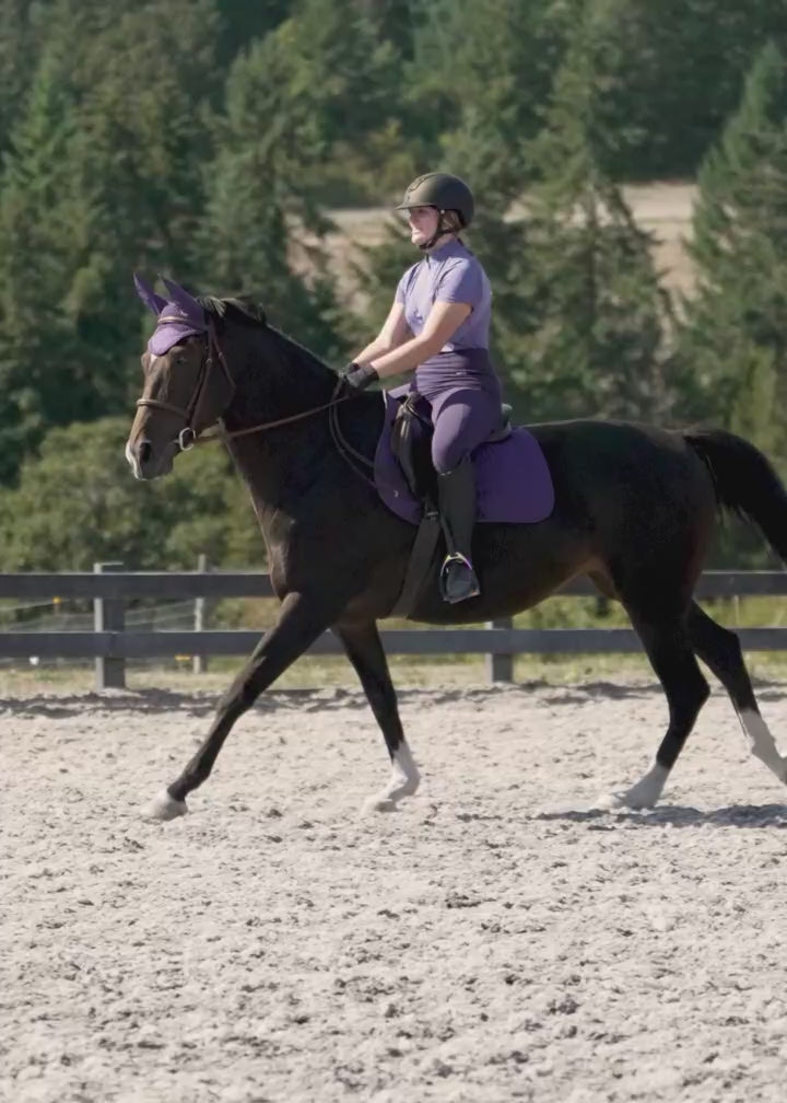 Video of equestrian wearing the Free Style Knee Patch Pocket Tight during an outdoor ride, highlighting the tights' performance in natural conditions.
