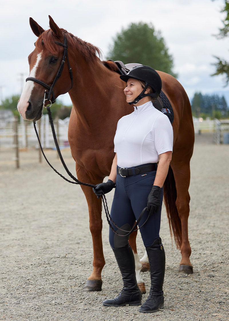 Person wearing the breeches in an outdoor setting, highlighting their classic equestrian style