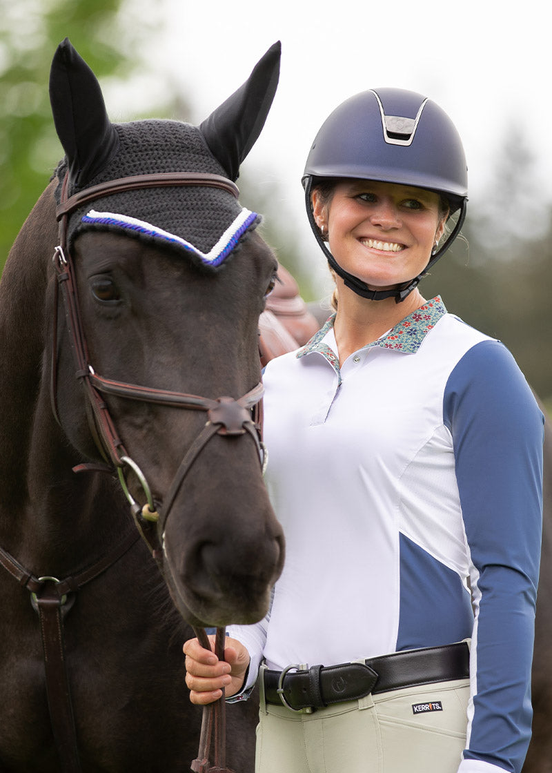Equestrian wearing the Simple D Leather Belt paired with riding breeches, demonstrating its fit and style in a riding context